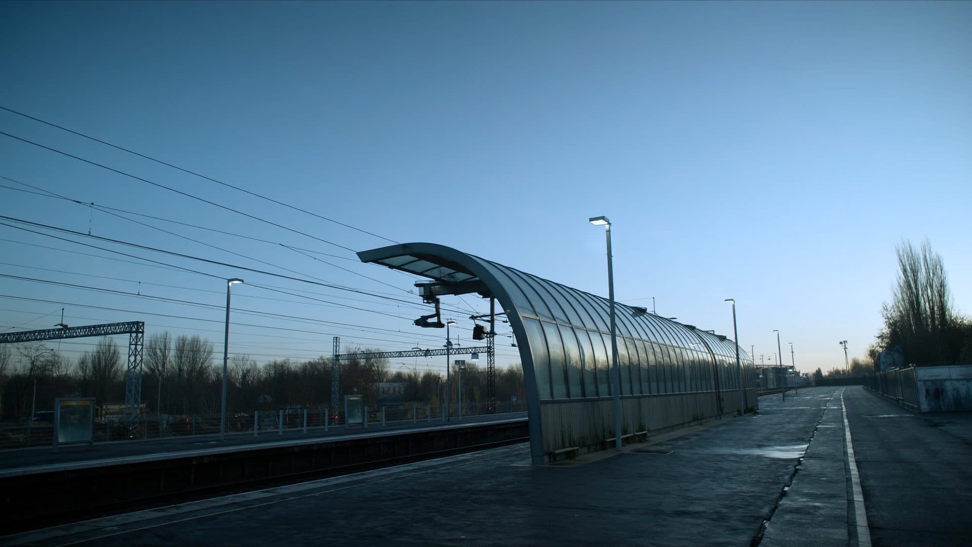 Illustrative: an empty railway station platform at dawn