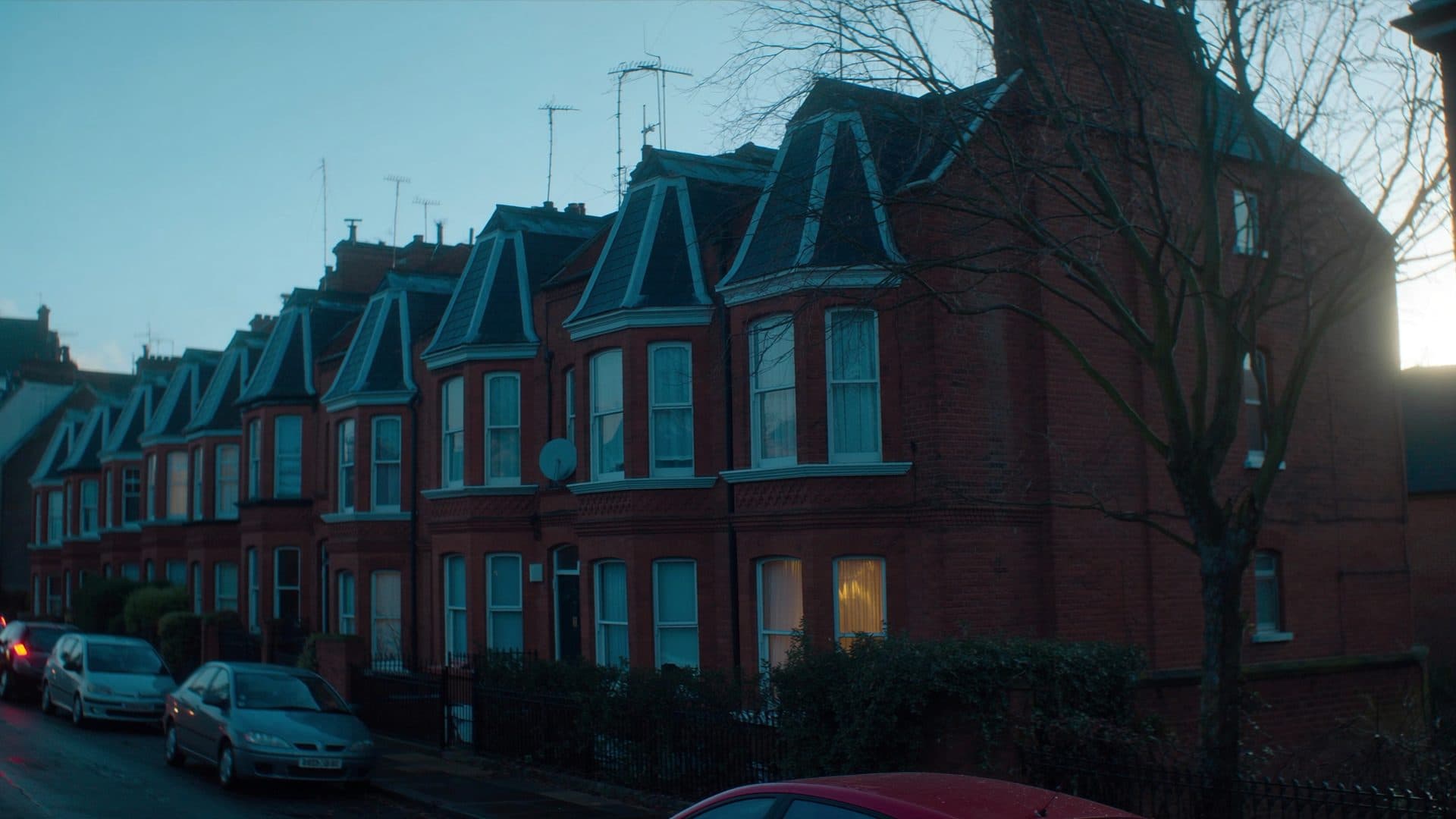 Illustrative: a street of Victorian terraced houses at dusk
